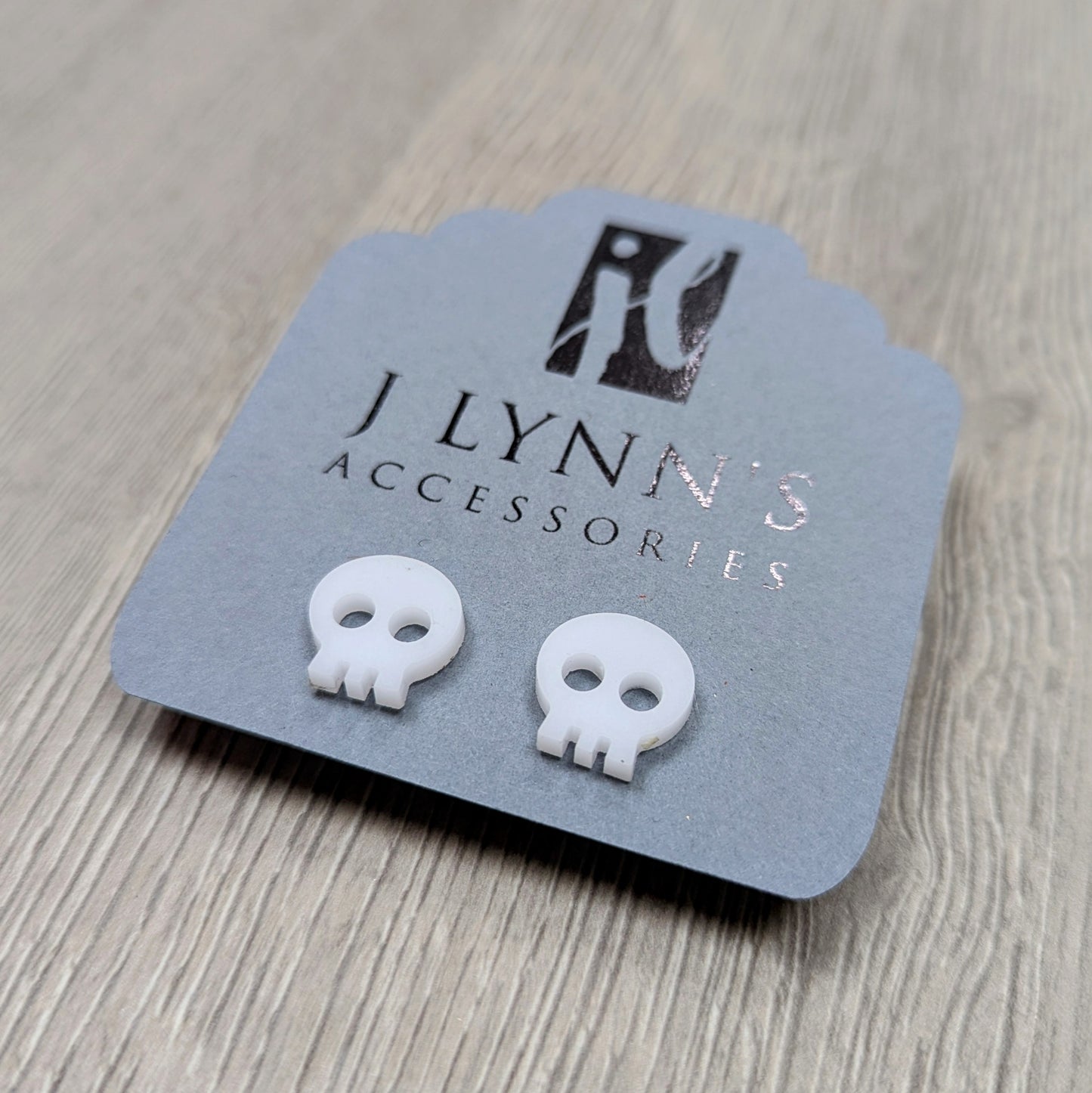 Acrylic skull earrings in white