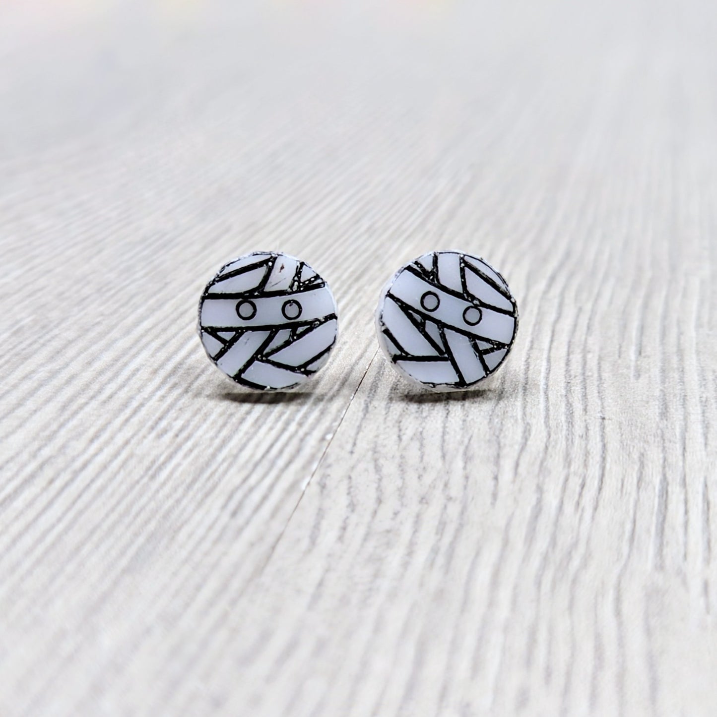 Acrylic mummy earrings in white with black detailing