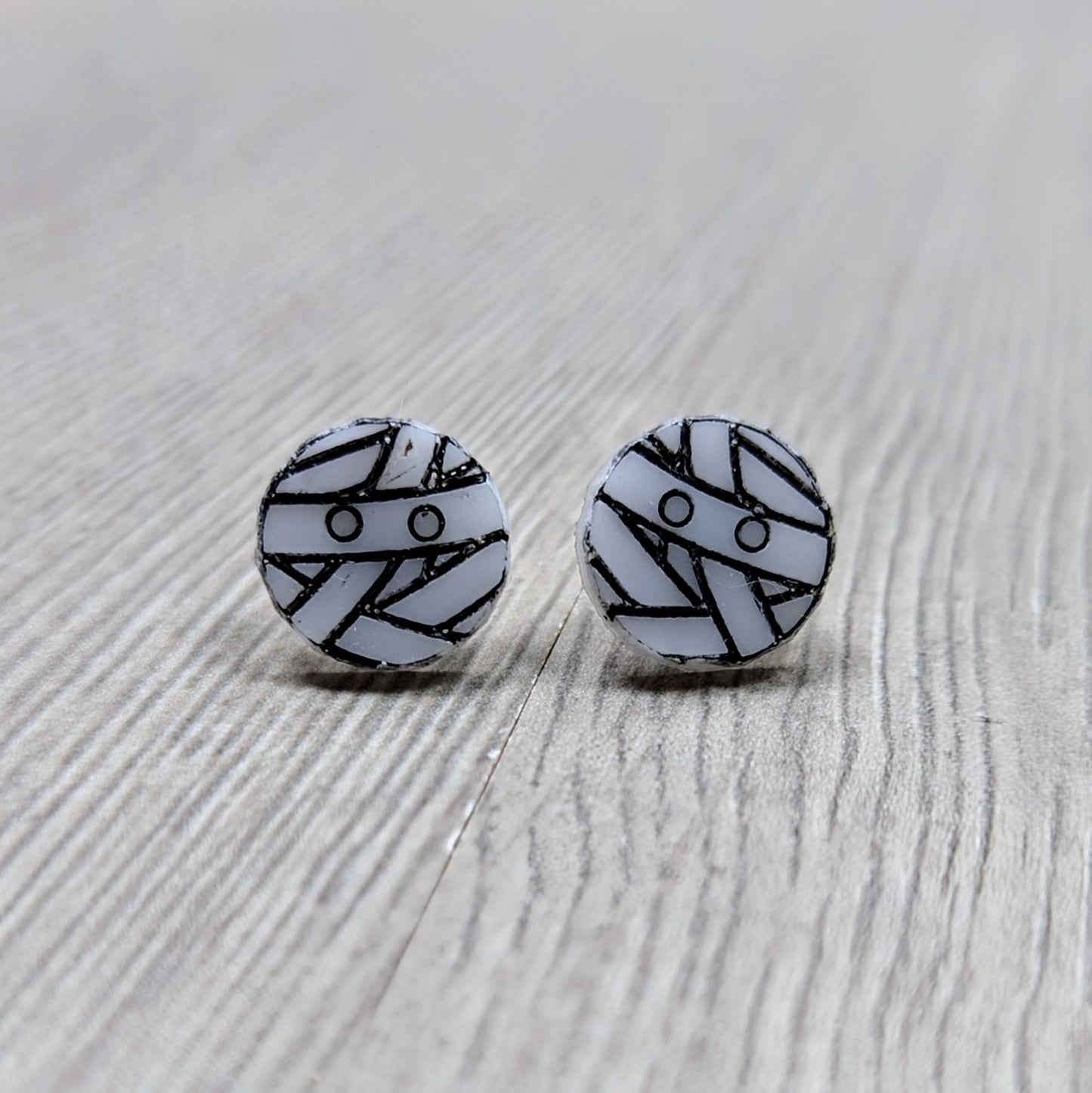Acrylic mummy earrings in white with black detailing